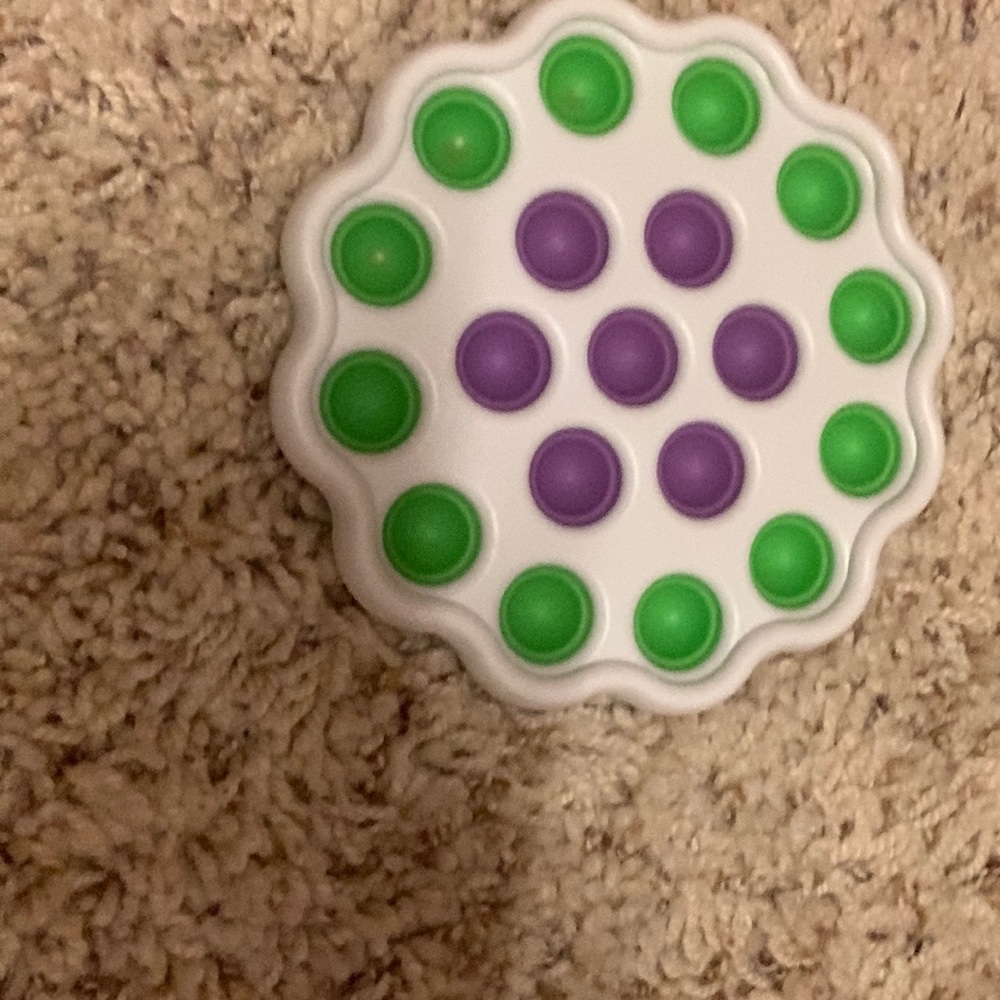 White shelled pop it with green and purple pops
